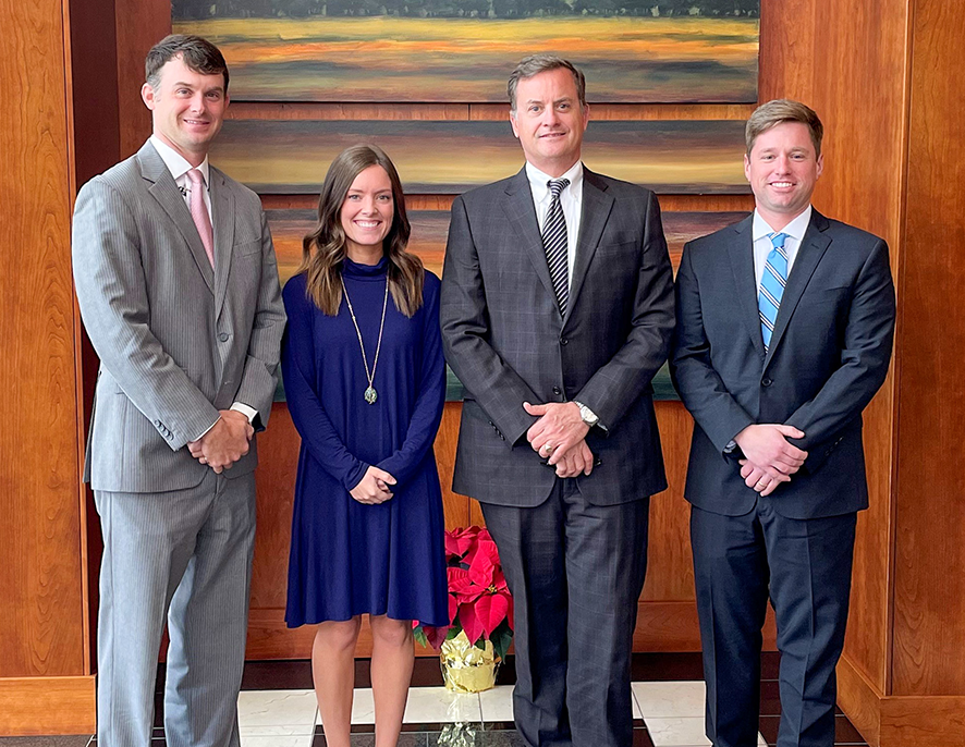 Group shot of 4 Southern First bankers in the bank.