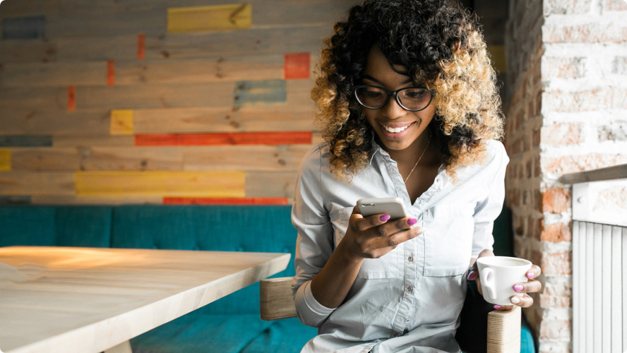 Woman looking at her phone and smiling.