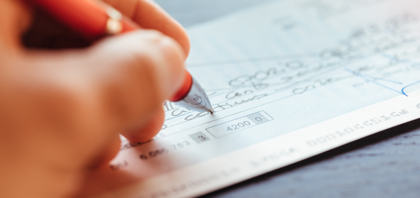 Hand writing a check.