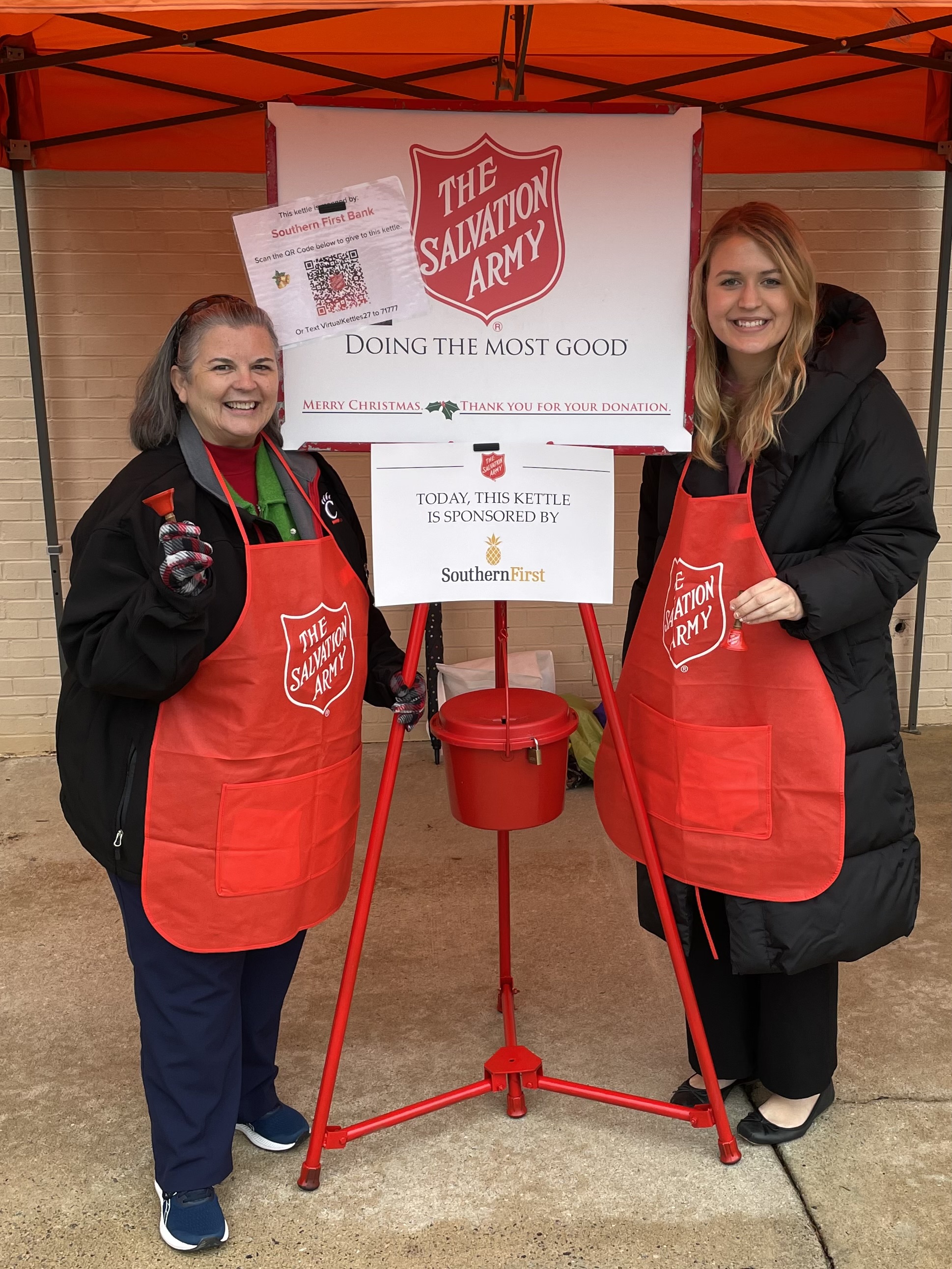 Two Southern First associates bell ringing for the Salvation Army's Red Kettle Campaign.