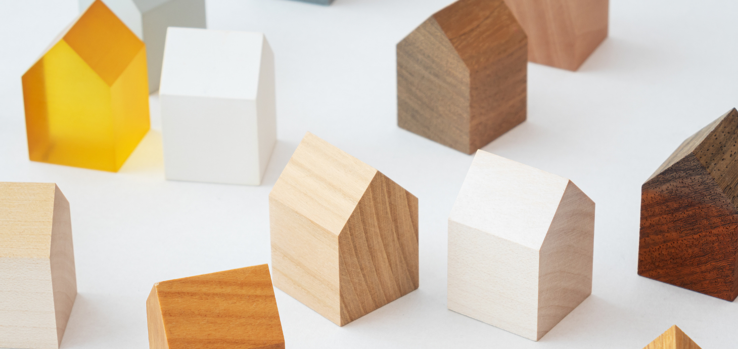 Image of tiny wooden houses on a white background.