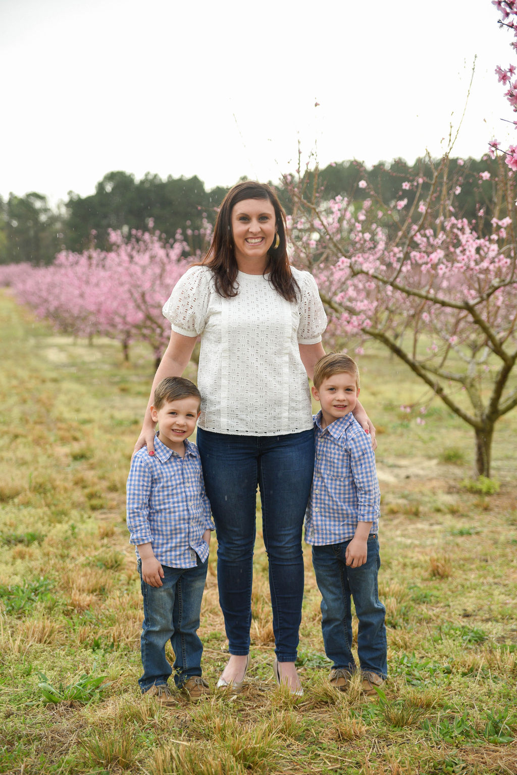 A mom with her two sons in a field.