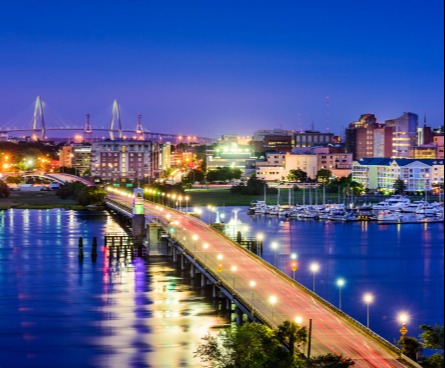 Charleston city view of bridge lit up at night.